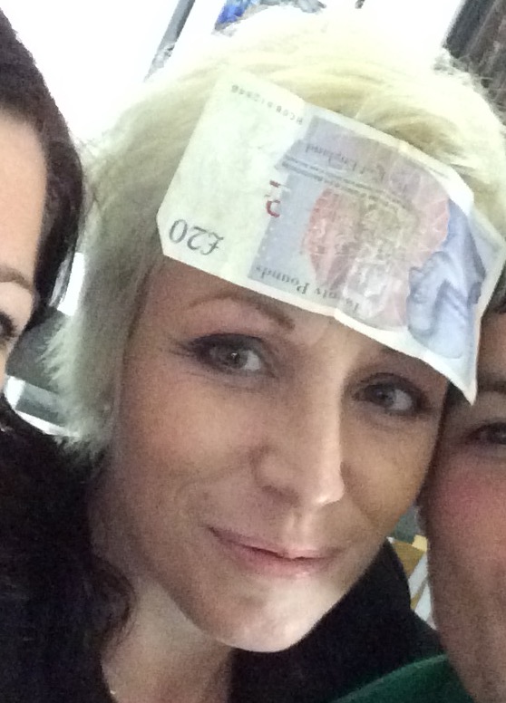 Sara with a £20 note stuck upside down on her forehead.