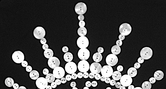 A crown made of pearl buttons sewn onto black fabric