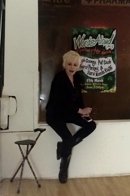 Sara sitting on a windowsill with her seat-stick nearby in case she needs it