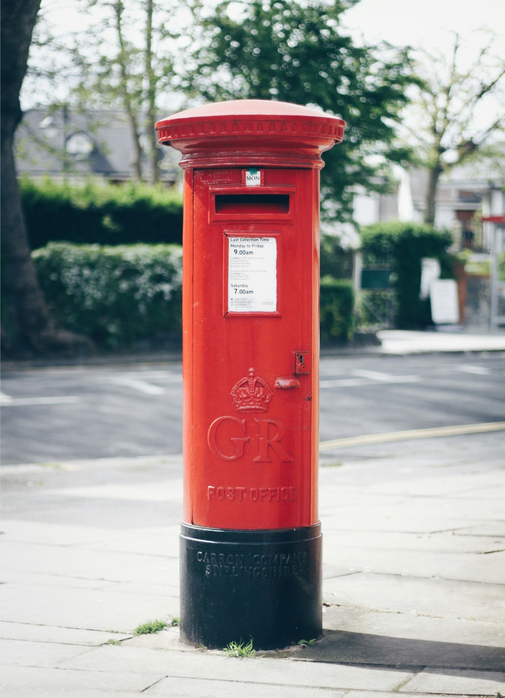 Red Post Box in a street somewhere in UK.