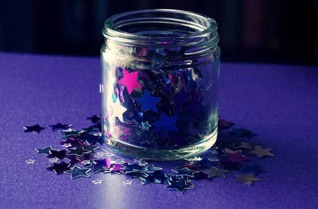 a jar full of metallic star confetti