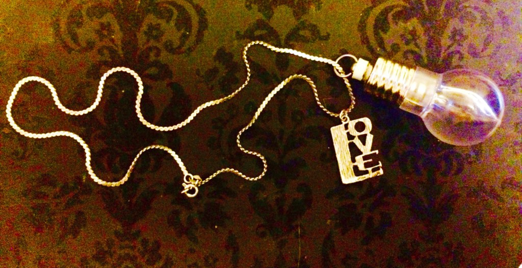 a necklace with love pendant and lightbulb pendant